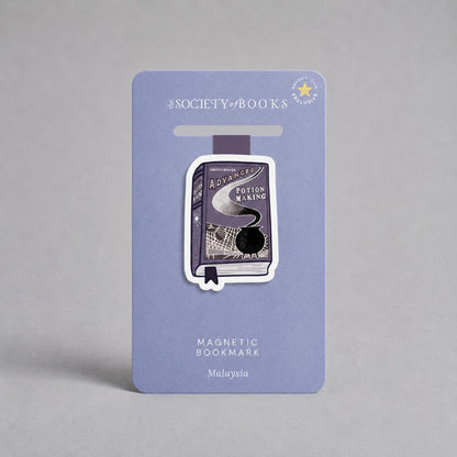 A book-themed magnetic bookmark mounted on a lavender card. The bookmark is shaped like a book cover with the title 'Advanced potion harry potter Making' and a black circular magnet visible inside.