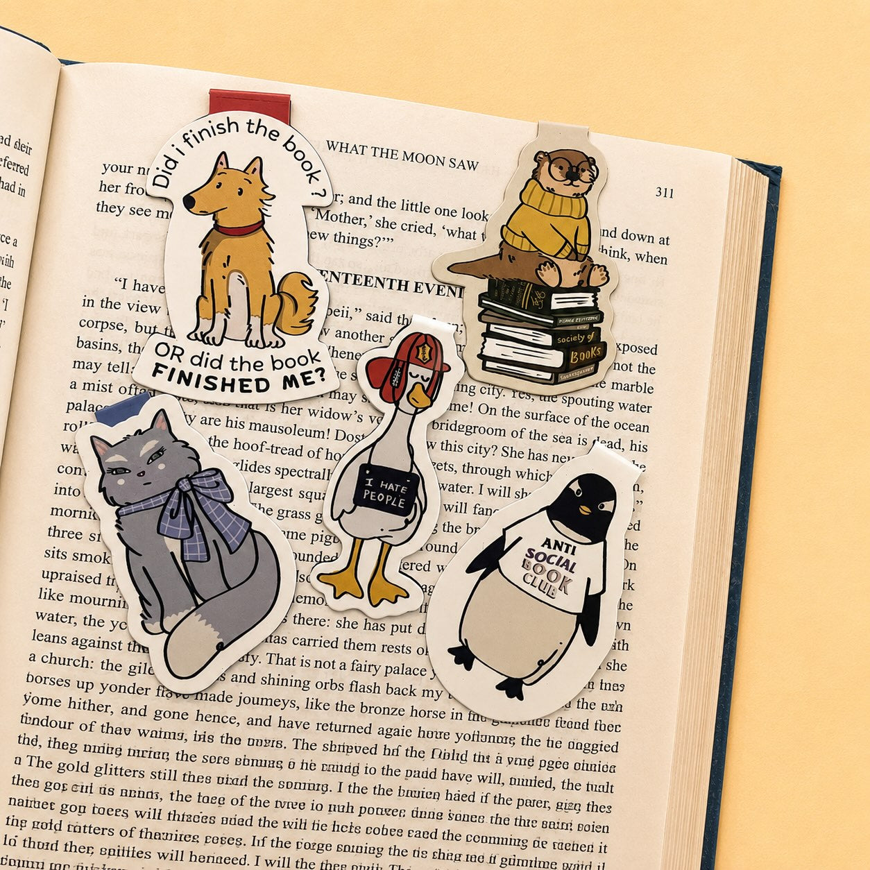 A flat-lay of a book page featuring a detailed die-cut sticker collage of a dog-themed life journey, complete with a golden retriever, a puppy, a dog collar, a leash, a dog bed, and a dog walker, all arranged on the printed pages of an open book.